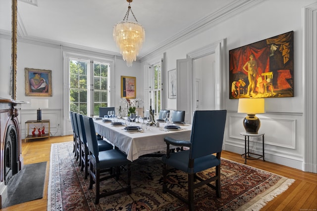 259 N Main St, Stonington, CT 06378 - dining room with ornamental molding, a decorative wall, a chandelier, and wainscoting