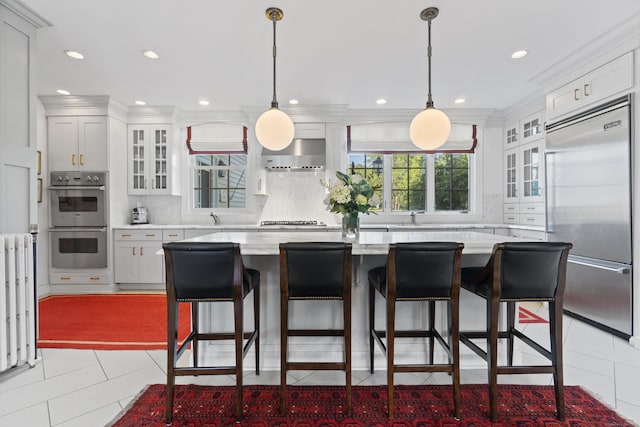 259 N Main St, Stonington, CT 06378 - kitchen featuring stainless steel appliances, a kitchen island, tasteful backsplash, white cabinetry, and recessed lighting