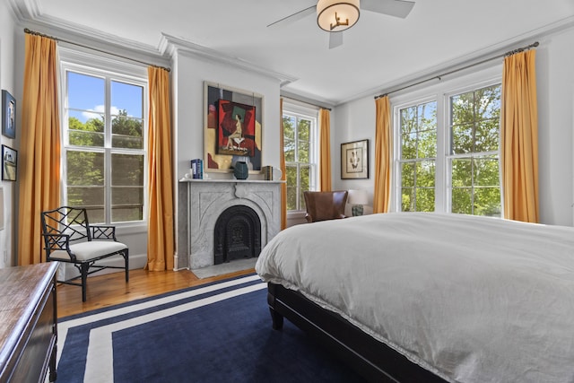 259 N Main St, Stonington, CT 06378 - bedroom with ornamental molding, wood finished floors, a fireplace, and a ceiling fan