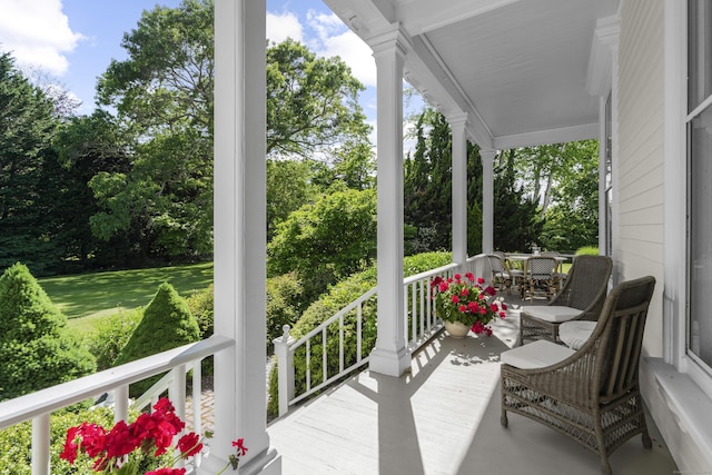 259 N Main St, Stonington, CT 06378 - wooden porch featuring view of wooded area