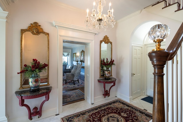 828 Sasco Hill Rd, Fairfield, CT 06824 - entrance foyer with arched walkways, ornamental molding, a chandelier, light marble finish floors, and baseboards