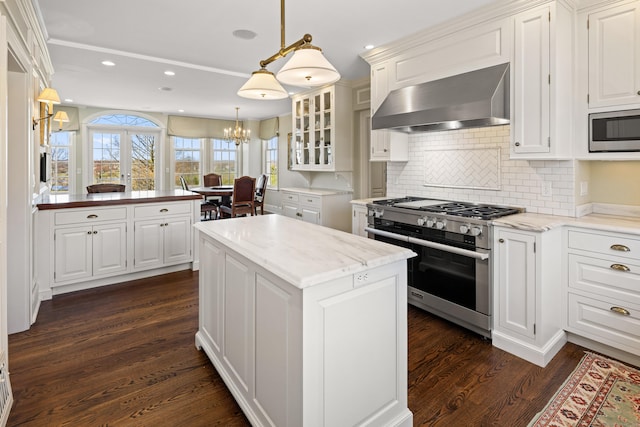 828 Sasco Hill Rd, Fairfield, CT 06824 - kitchen with stainless steel appliances, wall chimney range hood, white cabinetry, backsplash, and dark wood-type flooring