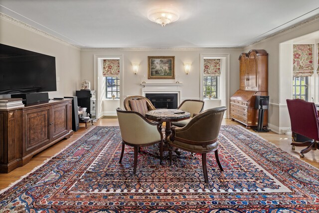 828 Sasco Hill Rd, Fairfield, CT 06824 - dining area with healthy amount of natural light, a fireplace, ornamental molding, and light wood-style floors