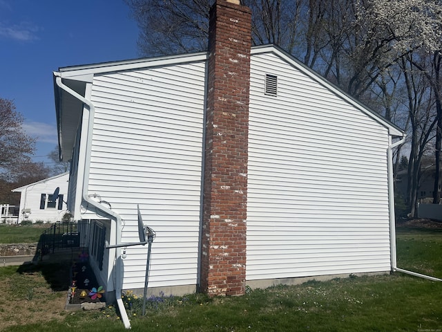 view of home's exterior featuring a chimney and a garage