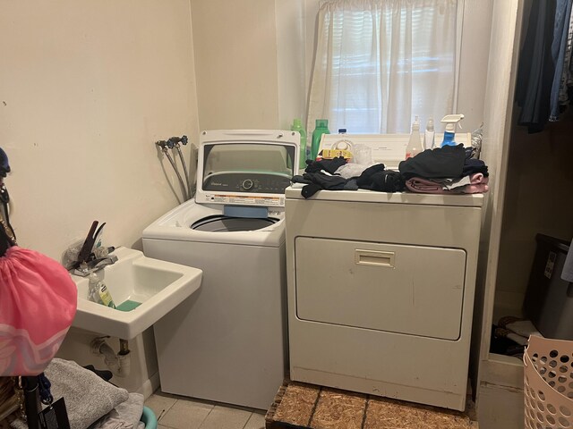 laundry area featuring light tile patterned floors, washer and dryer, and laundry area