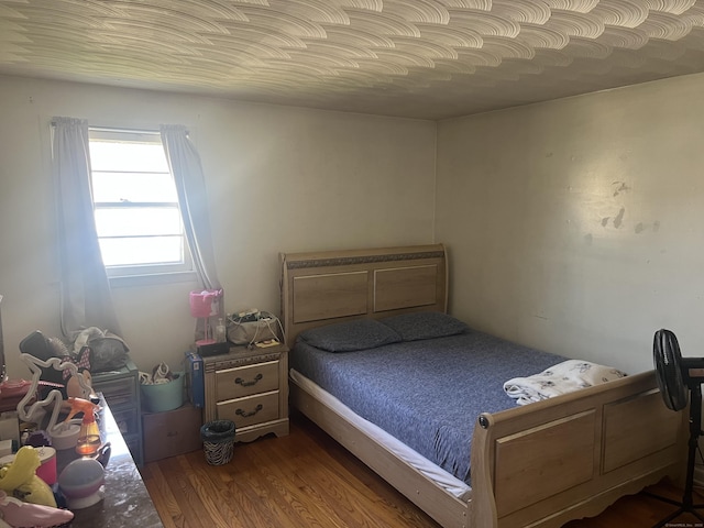 bedroom featuring wood finished floors
