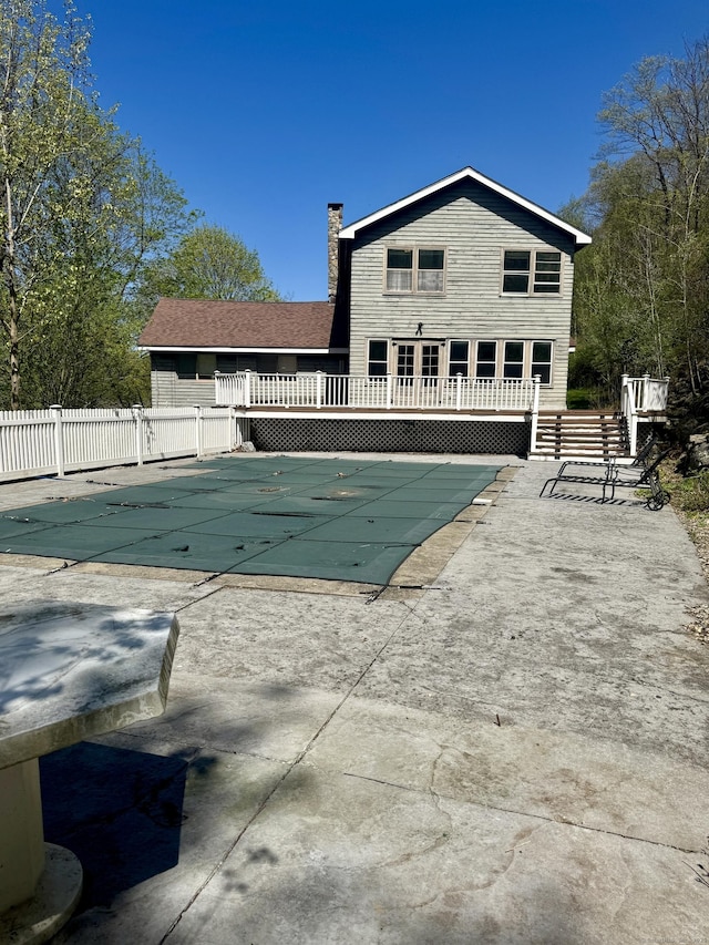 view of pool with fence, a fenced in pool, a patio area, and a deck