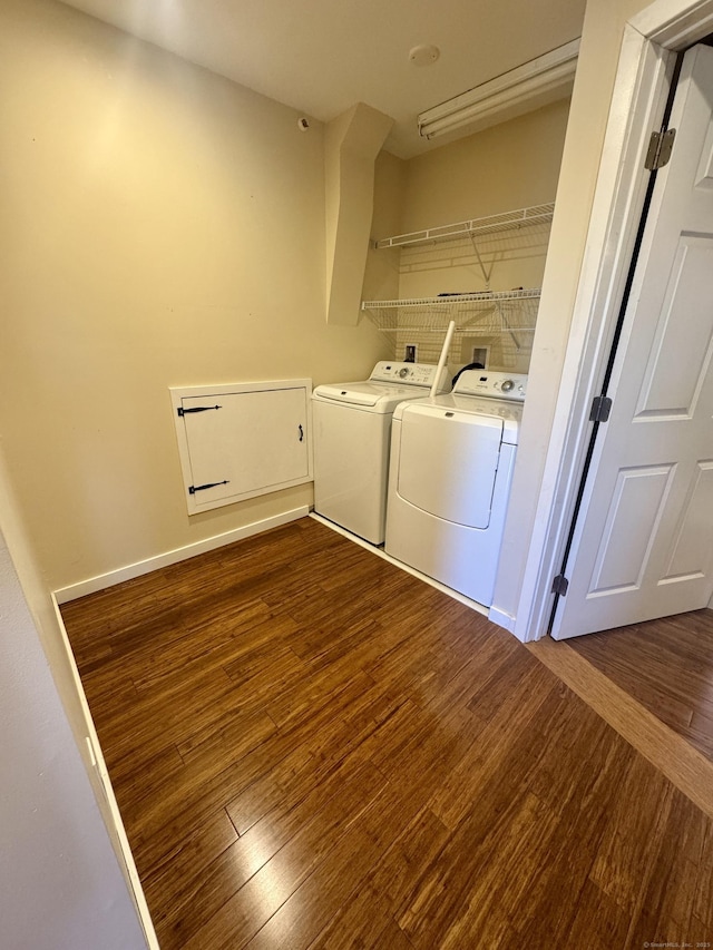 laundry area with laundry area, dark wood-style floors, and washing machine and dryer