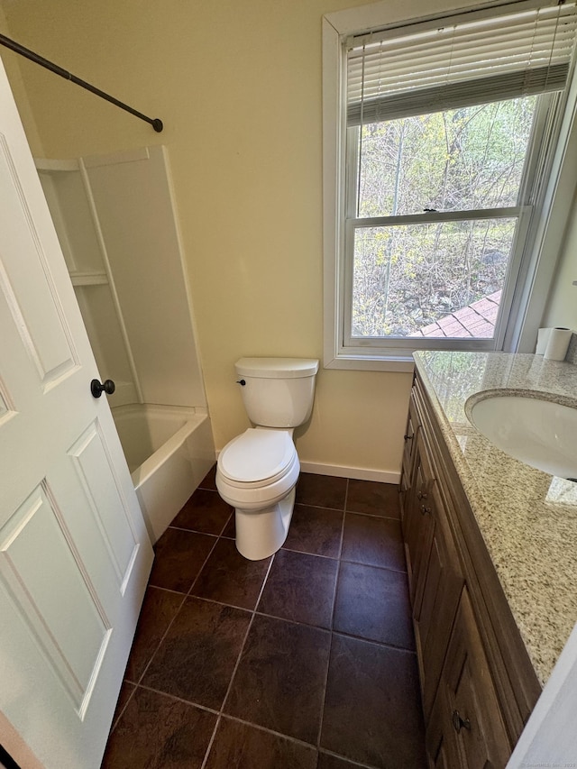 bathroom with vanity, toilet, tile patterned floors, baseboards, and shower / bath combination