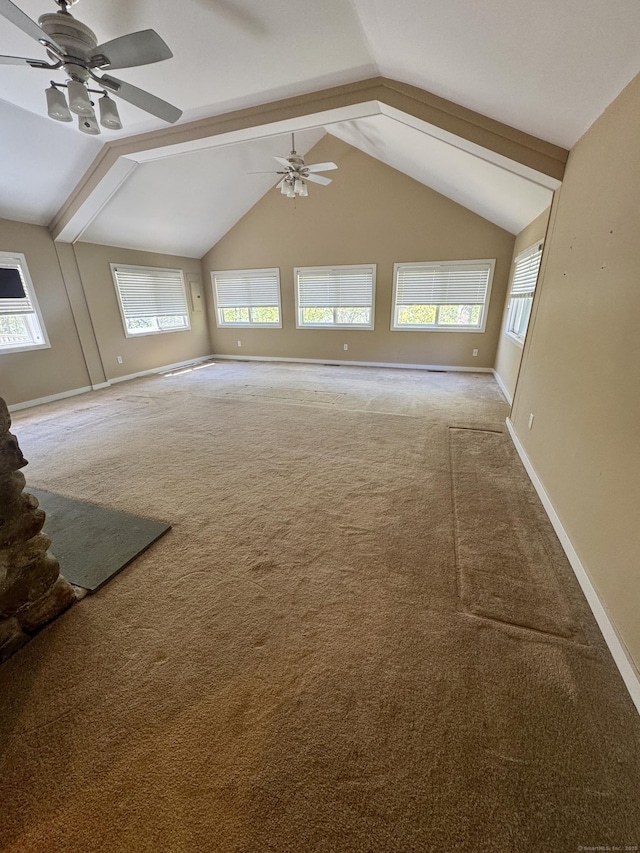 unfurnished living room featuring carpet floors, a ceiling fan, baseboards, and vaulted ceiling with beams
