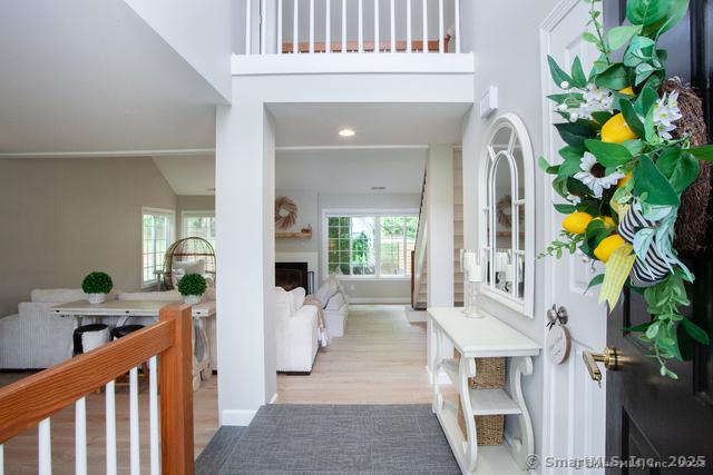 41 Stratton Forest Way, Simsbury, CT 06070 - foyer featuring wood finished floors, a fireplace, a high ceiling, and recessed lighting