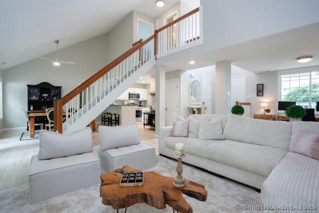 41 Stratton Forest Way, Simsbury, CT 06070 - living area with high vaulted ceiling, stairway, a ceiling fan, and baseboards