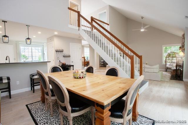 41 Stratton Forest Way, Simsbury, CT 06070 - dining area featuring stairway, plenty of natural light, high vaulted ceiling, light wood-type flooring, and baseboards
