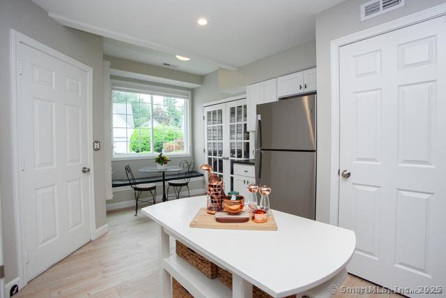 41 Stratton Forest Way, Simsbury, CT 06070 - kitchen with freestanding refrigerator, french doors, white cabinets, light wood-type flooring, and recessed lighting