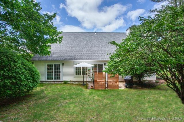 41 Stratton Forest Way, Simsbury, CT 06070 - back of property with a yard and roof with shingles