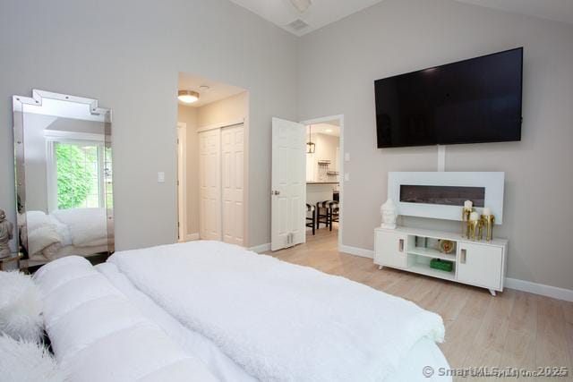 41 Stratton Forest Way, Simsbury, CT 06070 - bedroom featuring wood finished floors, baseboards, a closet, and a towering ceiling