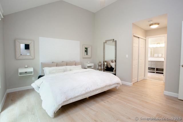 41 Stratton Forest Way, Simsbury, CT 06070 - bedroom featuring light wood-style flooring, baseboards, high vaulted ceiling, a closet, and connected bathroom