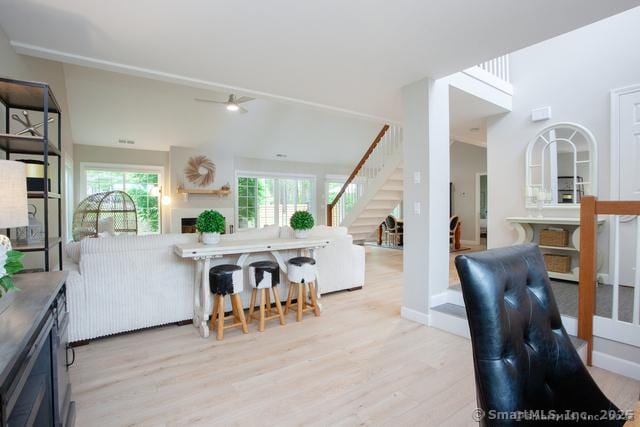 41 Stratton Forest Way, Simsbury, CT 06070 - living room with stairway, light wood-style floors, and a ceiling fan