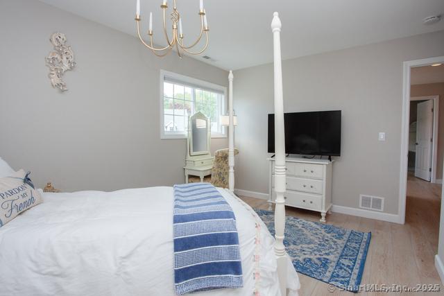 41 Stratton Forest Way, Simsbury, CT 06070 - bedroom with a chandelier, wood finished floors, and baseboards