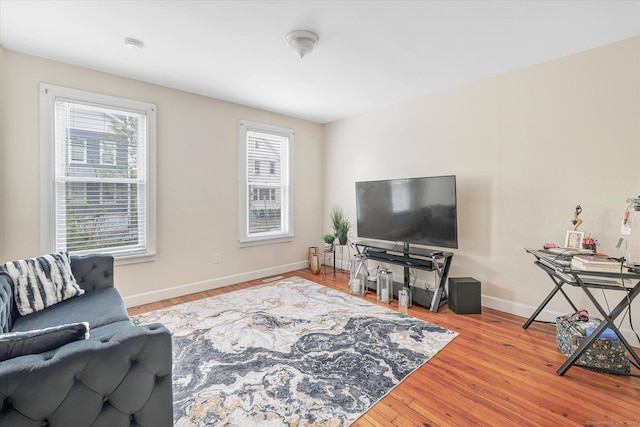 living room with baseboards and wood finished floors
