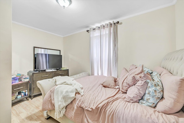 bedroom with light wood-style floors and ornamental molding