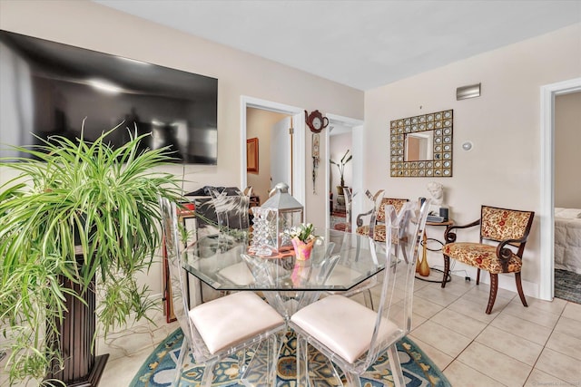 dining space featuring light tile patterned floors