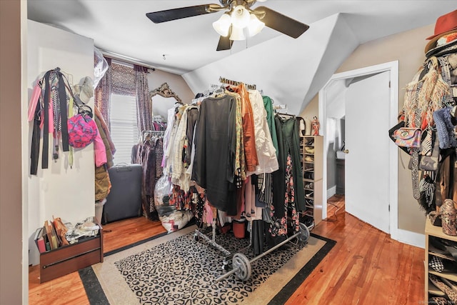spacious closet with a ceiling fan, wood finished floors, and lofted ceiling