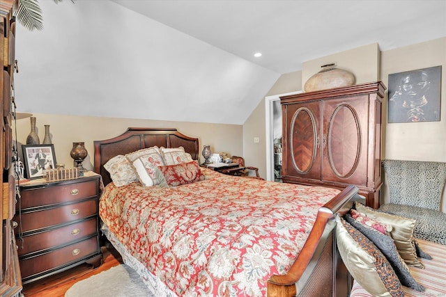 bedroom with wood finished floors, recessed lighting, and lofted ceiling