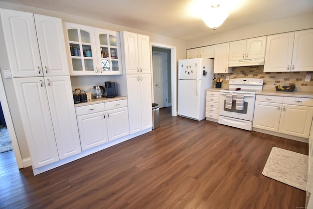 kitchen with white appliances, glass insert cabinets, under cabinet range hood, light countertops, and dark wood-style flooring