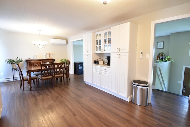 dining area featuring a notable chandelier, dark wood-type flooring, baseboards, an AC wall unit, and baseboard heating
