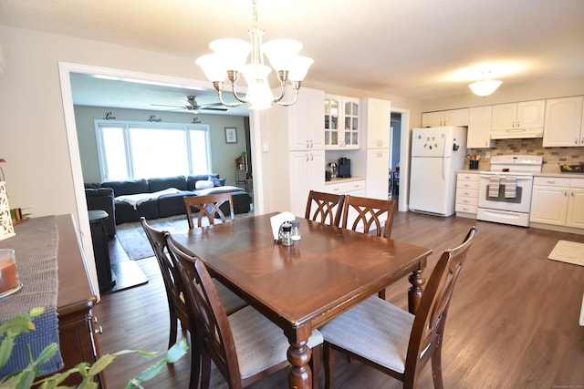 dining space featuring dark wood-style flooring and ceiling fan with notable chandelier