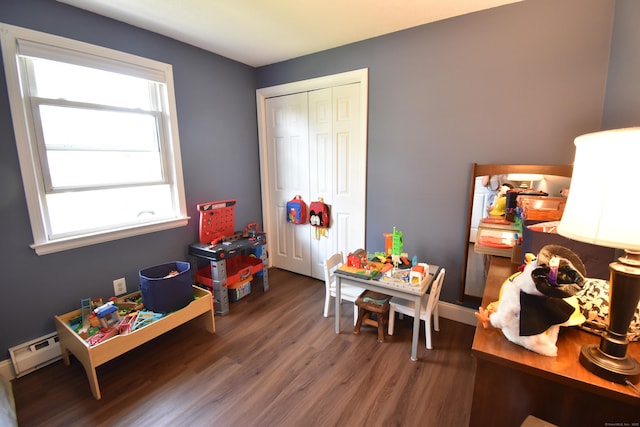 playroom with a baseboard radiator and wood finished floors