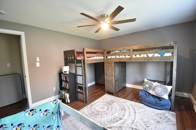 bedroom featuring wood finished floors and baseboards