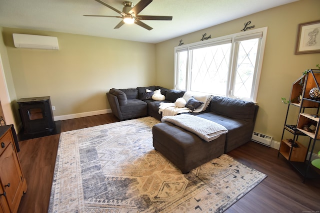 living area with dark wood finished floors, a baseboard heating unit, a wall mounted air conditioner, a wood stove, and a ceiling fan