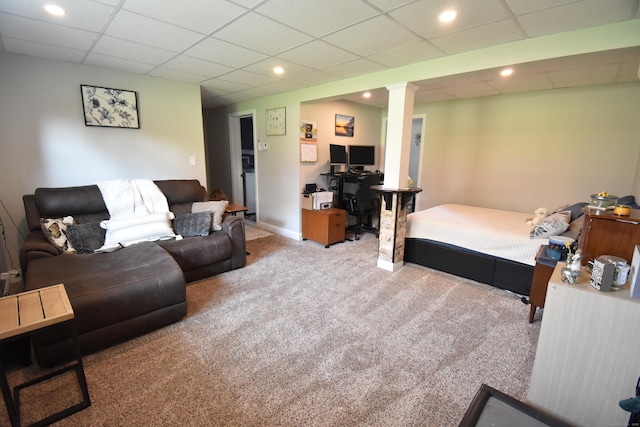 bedroom featuring recessed lighting, decorative columns, a drop ceiling, and carpet floors