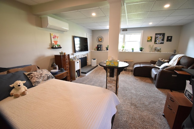 bedroom featuring recessed lighting, a fireplace with raised hearth, carpet, and an AC wall unit