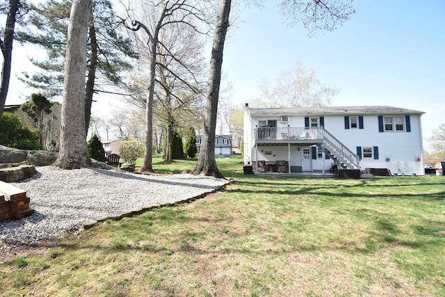 exterior space with a wooden deck, a yard, and stairs