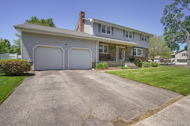 330 Flagler Ave, Stratford, CT 06614 - view of front of home with a garage, a chimney, a front yard, driveway, and a porch