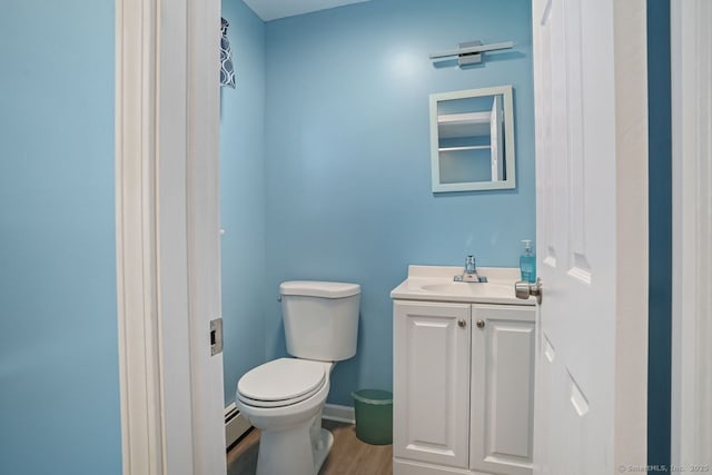 330 Flagler Ave, Stratford, CT 06614 - half bathroom with vanity, toilet, wood finished floors, and baseboard heating