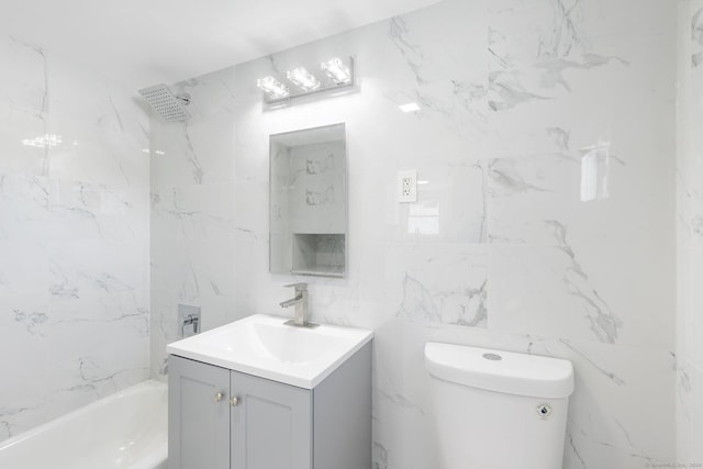 full bathroom with tile walls, toilet, bathtub / shower combination, and vanity