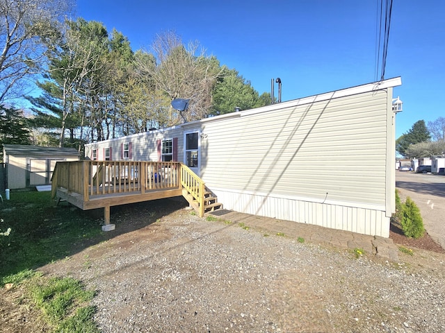 rear view of property featuring a wooden deck