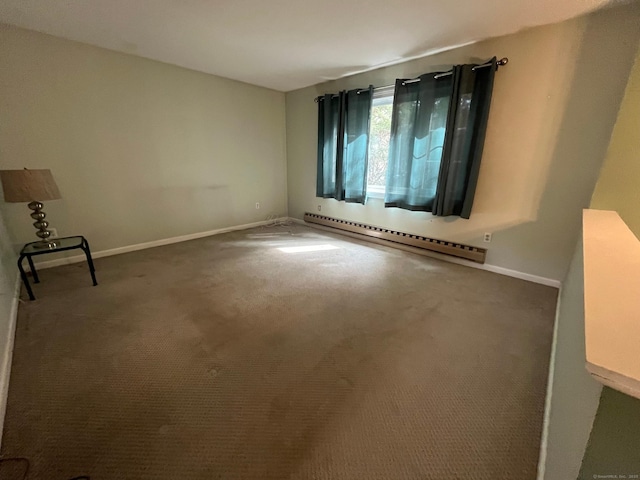 carpeted spare room featuring baseboards and a baseboard heating unit