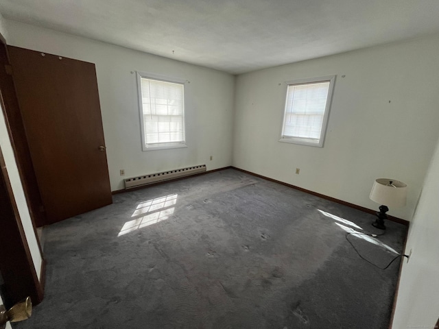 unfurnished bedroom featuring multiple windows, baseboard heating, carpet, and baseboards