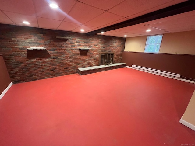 below grade area with a fireplace, carpet floors, a baseboard heating unit, and baseboards