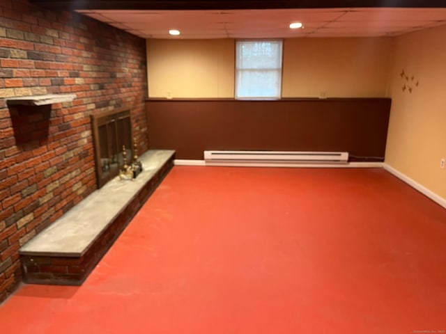 basement with a fireplace, carpet flooring, baseboards, and a baseboard radiator
