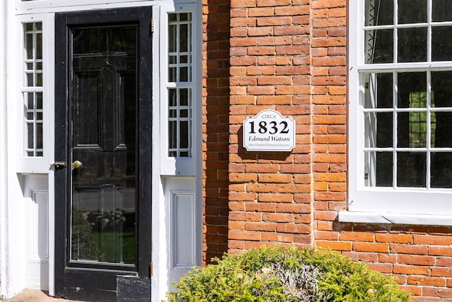 property entrance with brick siding