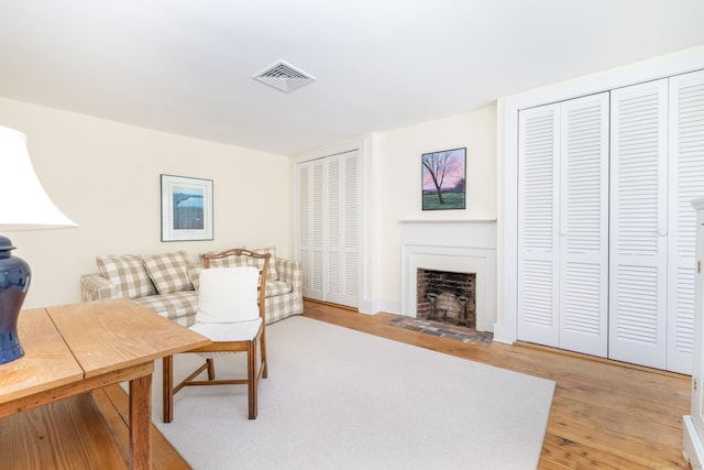 interior space with visible vents, light wood-type flooring, and a fireplace