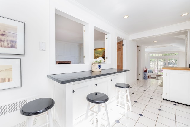 kitchen featuring recessed lighting, white cabinetry, and dark countertops