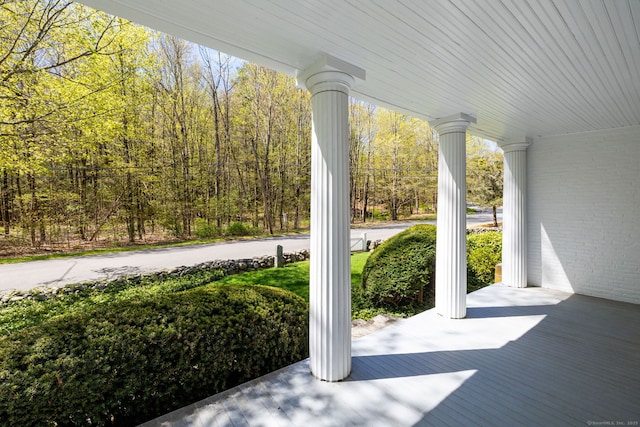 view of patio / terrace with covered porch and a wooded view