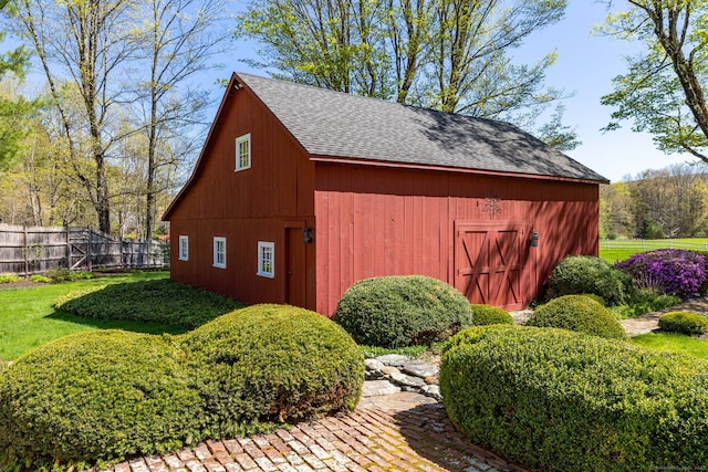 view of outbuilding with an outdoor structure and fence